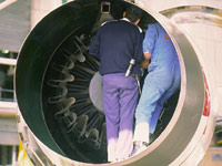 Mechanics working on aeroplane engine